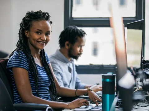 A woman working at a computer in Kenya